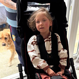 Child in their Snazzi supportive pushchair